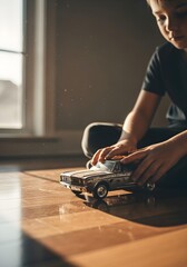 Child playing with old metal toy car on the floor