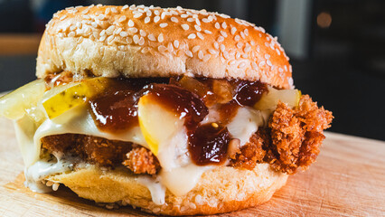 Korean fried chicken katsu burger with panko-crusted thigh, brioche bun, special sauces, pickles, and cheese. Crispy, juicy, and packed with flavor. Asian fusion delight.