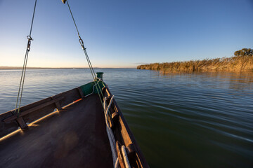 Albufera lake boat navigating peaceful waters at sunset