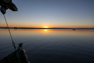 Albufera lake sunset from traditional boat in valencia