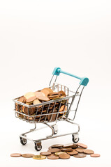 Retail Savings Strategy: Miniature Shopping Cart Filled to the Brim with Euro Cents and Loose Change