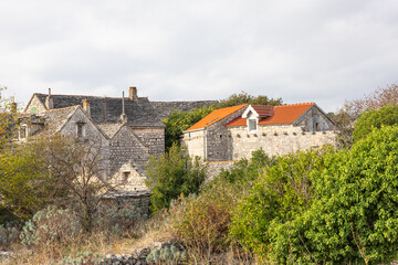 Charming Stone Village With Old Houses And Dry Stone Walls Under Cloudy Sky