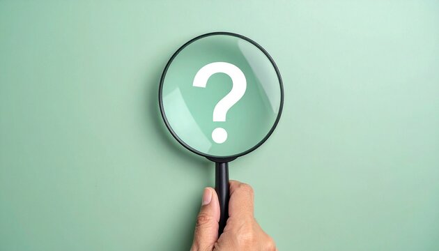 A hand holds a black magnifying glass against a green background, revealing a white question mark inside the lens to symbolize curiosity and inquiry.