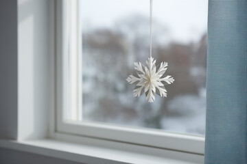 delicate paper snowflake clings to frosty window beautifully designed in minimalist style