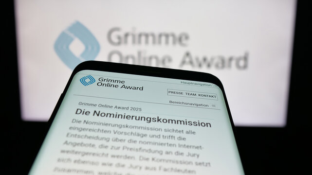 Stuttgart, Germany - 11-05-2025: Mobile phone with website of German media prize Grimme Online Award on screen in front of logo. Focus on top-left of phone display.