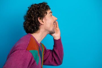 Man shouts in sweater blue background conveying bold lifestyle fashion expression and advertising vibe suitable for stock use