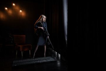 Obraz premium A Caucasian woman in a business suit holds a rifle with a scope. 