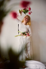 caucasian woman at-home florist arranging bouquet of tulips