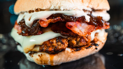 Juicy burger with special rub, melted cheese, onion chutney, and crispy bacon. Perfectly cooked and succulent, ideal for gourmet meals and promotions.