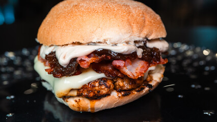 Juicy burger with special rub, melted cheese, onion chutney, and crispy bacon. Perfectly cooked and succulent, ideal for gourmet meals and promotions.