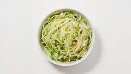 Bowl of julienned green zucchinis or cucumber with pile of white onion strands, healthy vegetable food, fresh produce, vegetarian dish, kitchen ingredients.