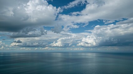 Obraz premium Vast ocean view with a cloudy sky, calm water, and expansive horizon. Nature and seascape scene. Sky and water environment. The concept of tranquility and natural beauty.