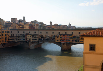 Arno River in Florence in Tuscany and the historic OLD Bridge also called Ponte Vecchio in Italian Language and the Vasari Corridor seen from above