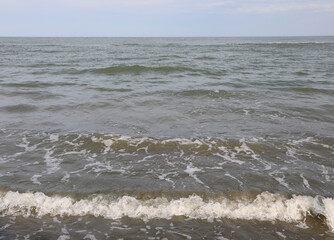 basic and simple background of the ocean wave crashing on the beach ideal as a customizable backdrop