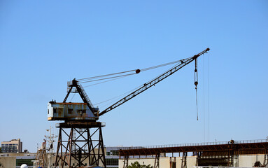 crane in the airport area of a major city industrial district for handling cargo and containers