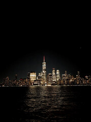 new york downtown manhattan panorama seen from the garden state over the waterway after dark