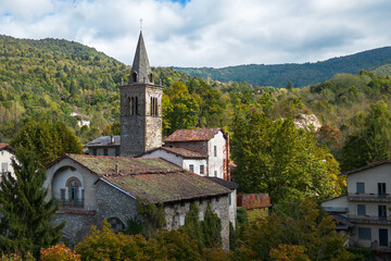 Fototapeta premium Old medieval church in Garessio surrounded by scenic autumn landscape located in Cuneo province, Piedmont region, Italy