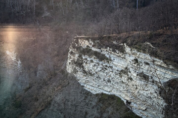 Spring evening landscape in Loazzolo, Asti region, Italy. Rocks and forest illuminated by warm light create a peaceful and natural atmosphere in the scenic Piedmont countryside.