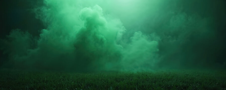 Green smoke hovers over field of grass. Dark eerie atmosphere. Conceptual photo conveys mystery. Perfect wallpaper for Halloween eco themed background. Use for banner eco project. Polution concept.