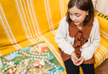 Happy father and child playing board game at home - happiness and family concept.