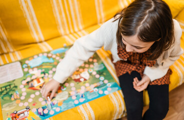 Happy father and child playing board game at home - happiness and family concept.