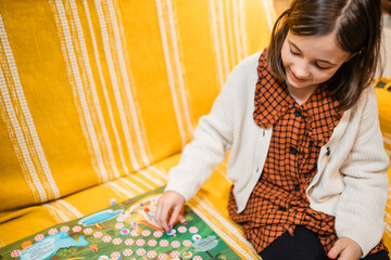 Happy father and child playing board game at home - happiness and family concept.