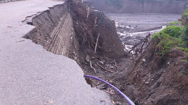 Flood water washing away road in India