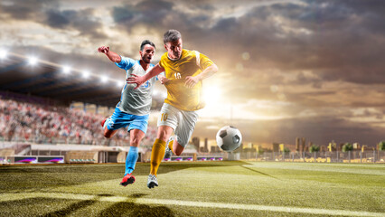 Soccer players in action on the sunset stadium background. Panorama. Sports concept. Football players. The decisive match. Soccer championship.