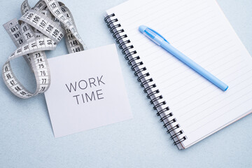 Fitness progress tracking: measuring tape, "Work Time" note, and calendar for health and body goals