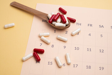 Dosage of pills by day, medication calendar, pill organizer with copy space
