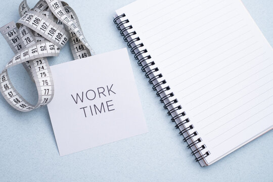 Measuring tape, "Work Time" note, and calendar for health and body goals. Fitness progress tracking. - Powered by Adobe