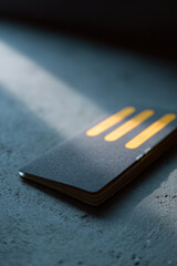 passport featuring ar data with blurred white text bars is placed against chalk wall backdrop creating clean and