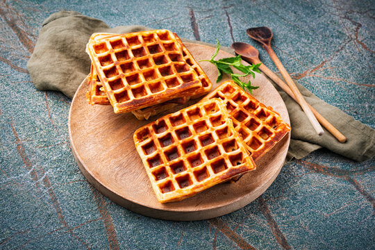 Fresh baked homemade Brussels waffles served as close-up on a wooden board