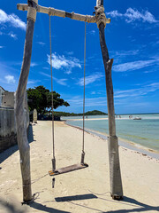 Wooden swing to play on a beautiful tropical white sand beach in Chaweng, Koh Samui island, Thailand. Holidays travel destination scene