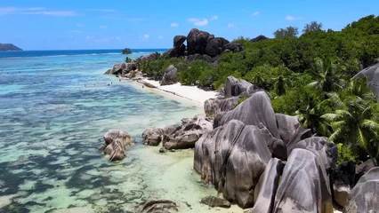 Gardinen Korallentiere Luxury resort photo of Seychelles tropical paradise islands in Indian Ocean with palm trees, sandy beach, stones. Beautiful photography, coral reef, azure ocean,  sky with clouds on horizon.    © TKalinovskaya
