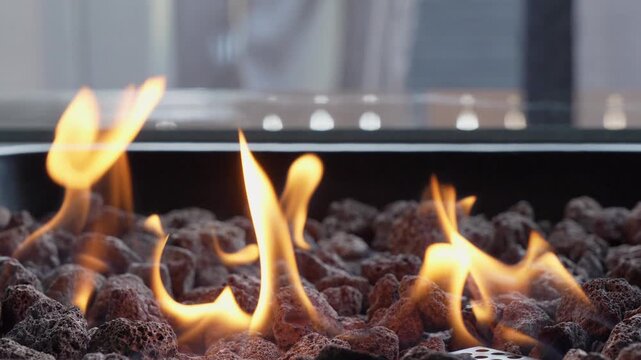 Backyard fire pit burning during summer evening. Close up view of flames of firepit on backyard. Slow motion video.
