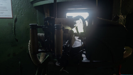 rusty machinery in shadows, old engine compartment illuminated by faint light and decayed structures
