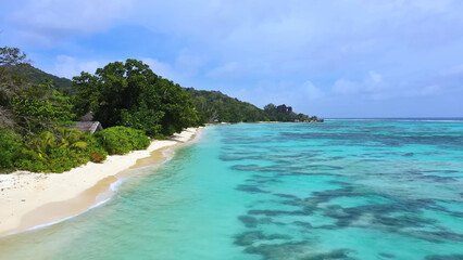 Luxury resort photo of Seychelles tropical paradise islands in Indian Ocean with sandy beach.
Beautiful photography, coral reef, azure ocean, 
sky with clouds on horizon.  