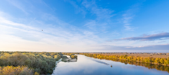 River with a boat on it and a bird flying in the sky