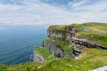 O'Brien's tower _ built in 1835 _ is seen in the distance at the Cliffs of Moher on the southwestern edge of the Burren region in Ireland.