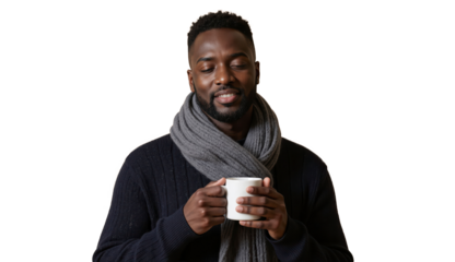 A cheerful man enjoys a warm drink while smiling warmly during a calm and cozy moment
