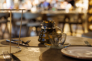 Elegant evening tea setup in a cozy restaurant with warm ambient lighting