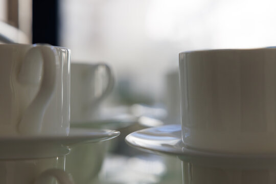 Warm coffee cups waiting on the table as sunlight gently fills the room