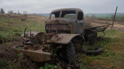 early morning vintage truck repair, old automobile rejuvenation during sunrise in misty open fields