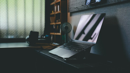 Dark and Moody Home Office Setup with Laptop and Smartphone
