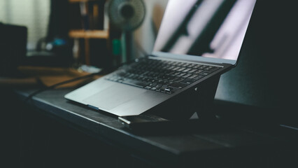 Dark and Moody Home Office Setup with Laptop and Smartphone