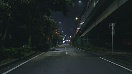 Empty and Quiet Asphalt Road Under the Highway at Night - Urban Solitude and Mystery / 夜の高速道路下の空っぽで静かなアスファルト道路
