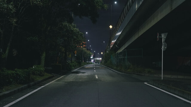 Empty and Quiet Asphalt Road Under the Highway at Night - Urban Solitude and Mystery / 夜の高速道路下の空っぽで静かなアスファルト道路