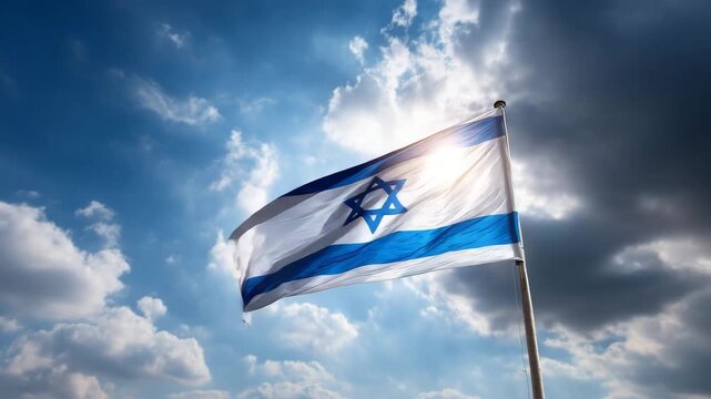Israeli national flag waving in the wind against bright sky with sunlight and moving clouds symbol of country identity and freedom