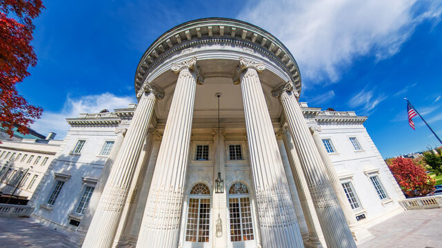 Historic government structure with American flag and fall foliage. wide-angle photo.
